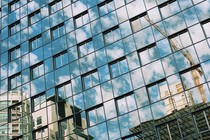 A reflection of a crane constructing new buildings
