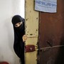 A woman whose family members are accused of being Islamic State militants enters a guarded building at a temporary camp for displaced people near the northern Syrian village of Ain Issa in 2017.