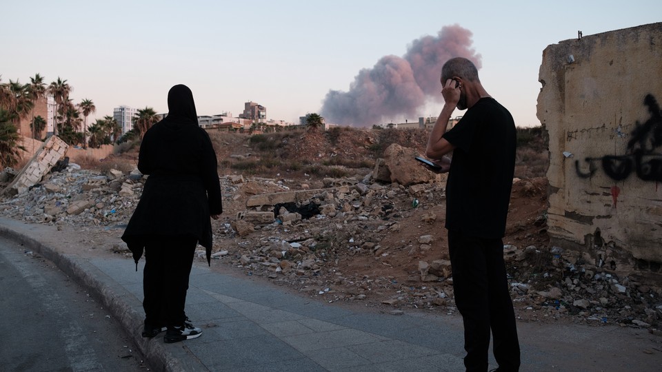 People in Beirut view the smoke rising above the site of an Israeli strike on Hassan Nasrallah.