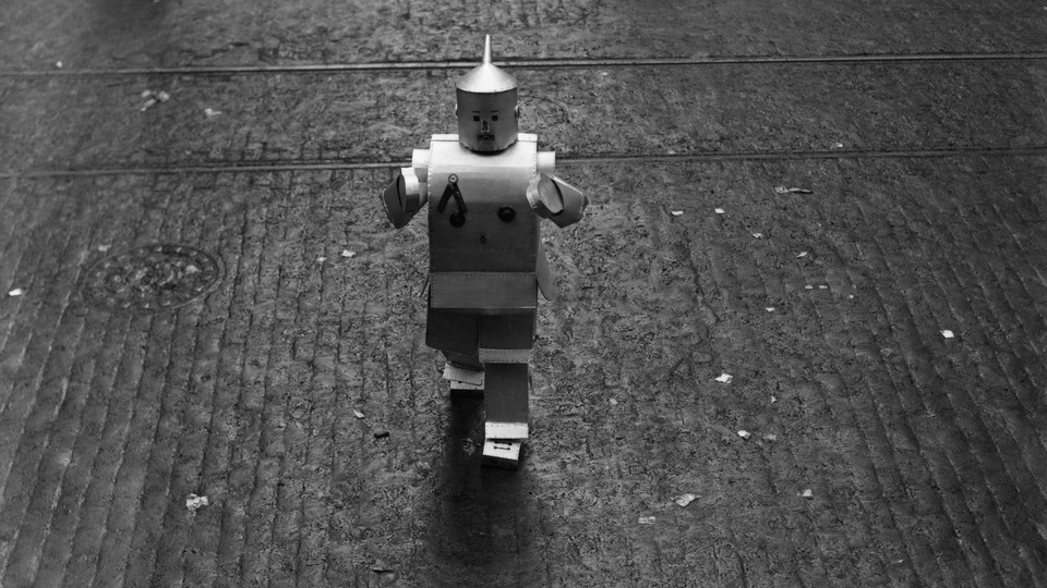 A tiny robot walking on a road