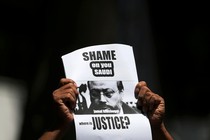 A protestor holds a sign that reads, "Shame on you Saudi. Where is justice?"