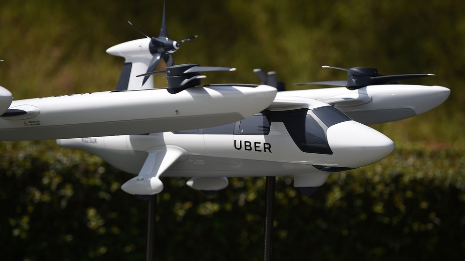 A model of Uber's flying taxi is displayed at the Uber Elevate Summit on May 8, 2018.