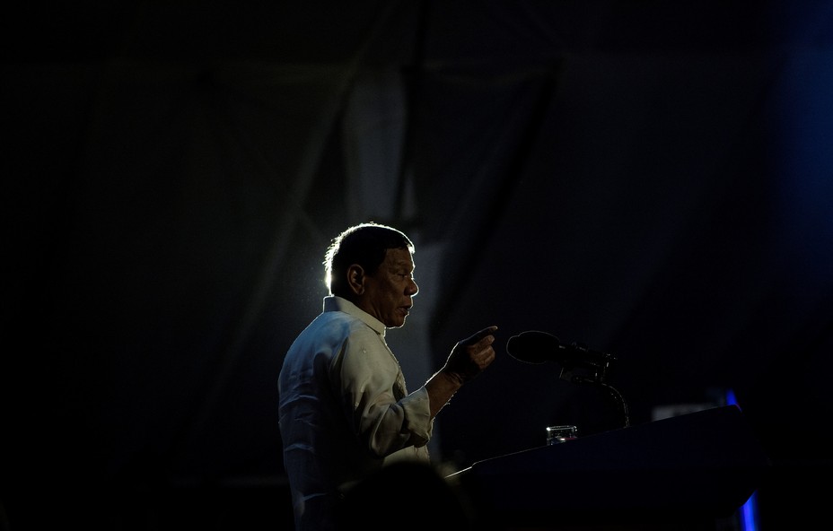 Philippines President Rodrigo Duterte delivers a speech in front of a podium.