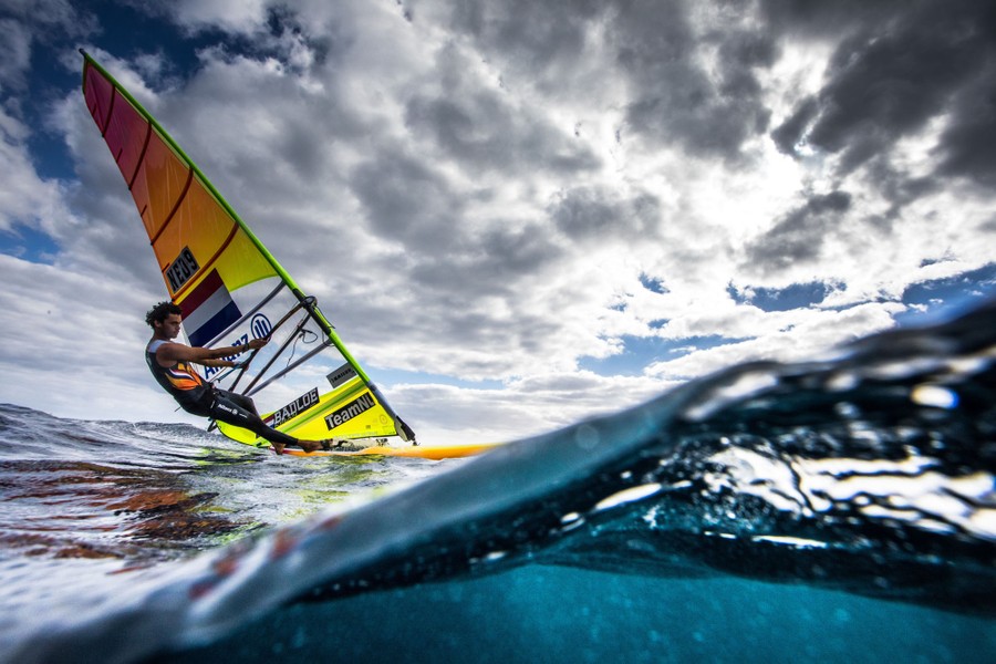 A person windsurfs on a cloudy day.