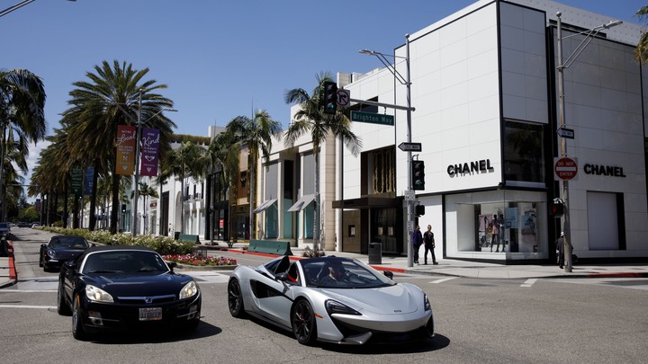 Two cars at a shopping mall in California