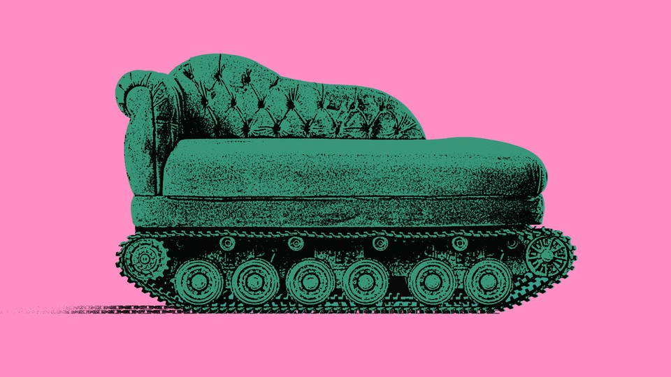 green couch on tank wheels against a pink background