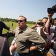 Alex Jones surrounded by people holding cameras