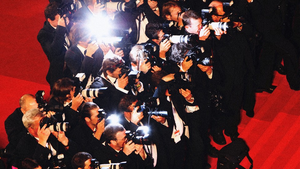 A gaggle of photographers on a red carpet