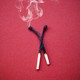 Close-up of two spent matches on red background.