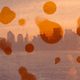 A fuzzy photo of the skyline of NYC with orange circles overlaying