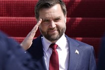 J. D. Vance smiles as he does a salute