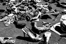 a black-and-white photo of discarded high-heel shoes