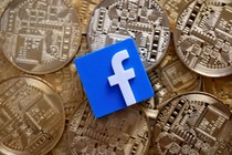 A 3-D printed Facebook logo is seen on representations of the bitcoin virtual currency in an illustration picture