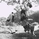 A black and white photo of girls playing outdoors in front of a light pink background