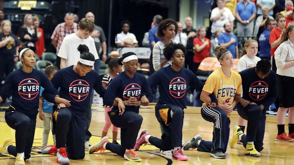 Indiana Fever kneel during the national anthem
