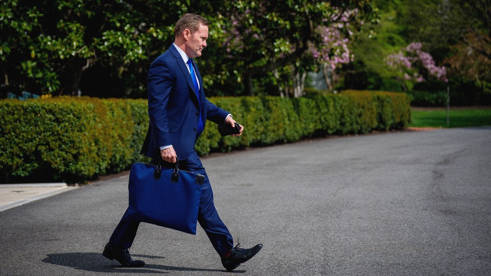 A color photograph of Michael Waltz crossing a driveway on the White House grounds.