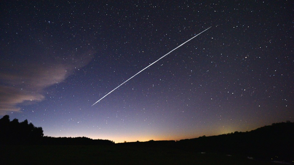 A long-exposure image of Starlink satellites passing overheard in the night sky over Uruguay