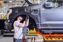 A man works on an electric car