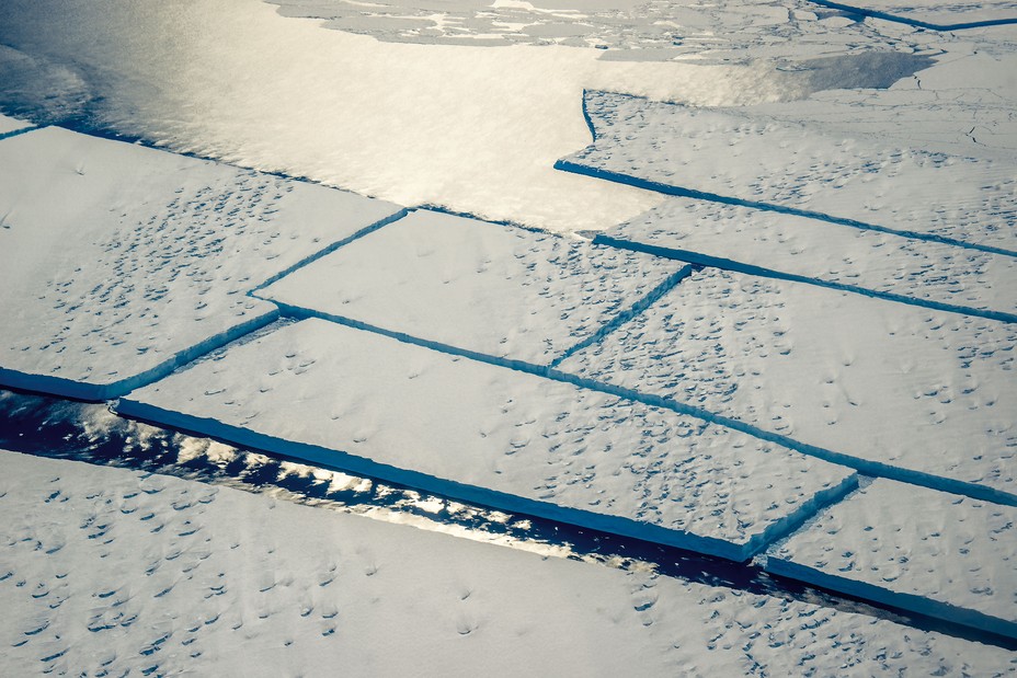 photo of large rectangles of blue-edged ice floating together in grid pattern