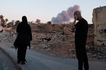 People in Beirut view the smoke rising above the site of an Israeli strike on Hassan Nasrallah