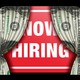 An illustration that shows curtains made of one-dollar bills revealing a "Now Hiring" sign
