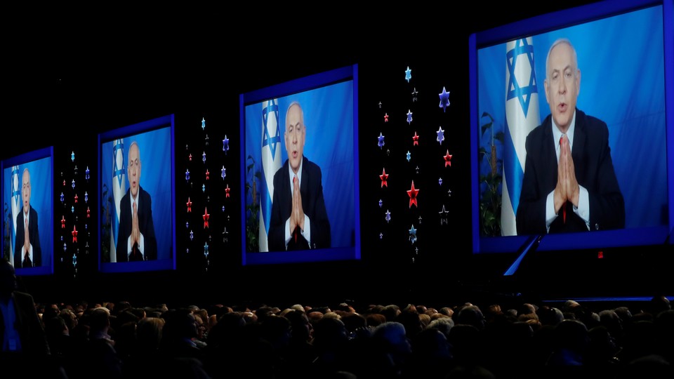 Speaking via satellite feed from Israel, Israeli Prime Minister Benjamin Netanyahu addresses AIPAC on March 26.