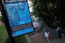 A sign on the Georgetown University campus reads "The Spirit of Georgetown: Education the whole person"