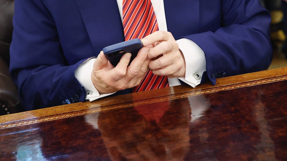 Donald Trump's hands holding a phone
