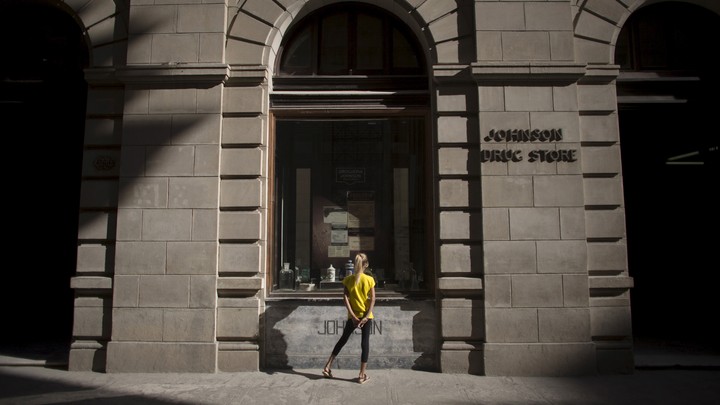 A girl looks into a shop window