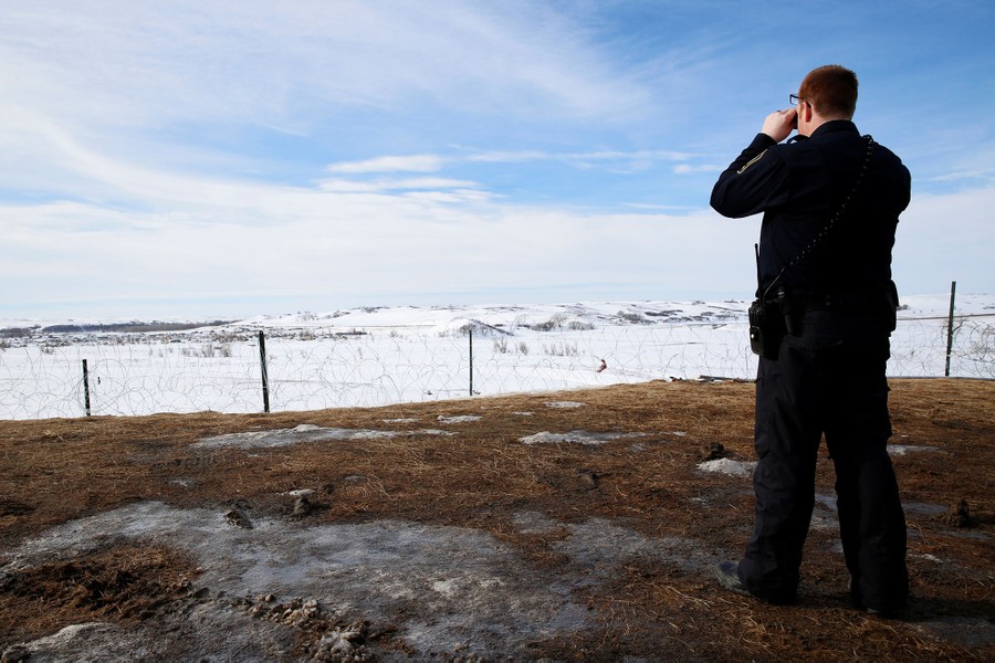 A police officer monitors the outskirts of the Dakota Access oil pipeline protest camp near Cannon Ball, North Dakota, on January 29, 2017.