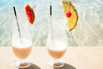 Photograph of two tropical drinks by the pool