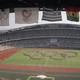 Flags frame the Olympic Stadium as participants form the Olympic rings on the field.