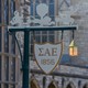A sign on a lamppost with the initials of Sigma Alpha Epsilon on it