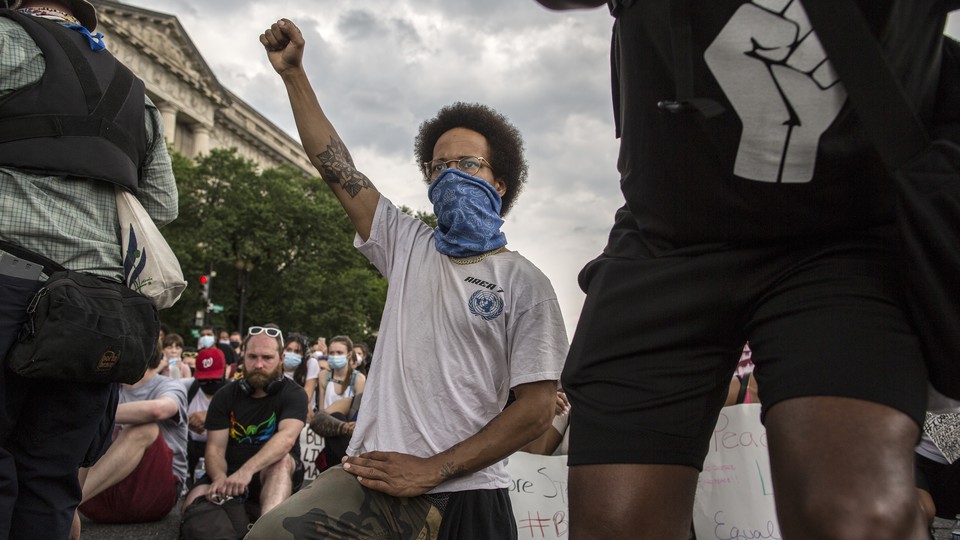 A demonstrator in D.C. raises a fist while protesting against police brutality and racism. This is the 12th day of protests with thousands of people descending on the city to peacefully demonstrate in the wake of the death of George Floyd, an African-American man who was killed in police custody in Minneapolis on May 25. (Photo by Probal Rashid / LightRocket via Getty)