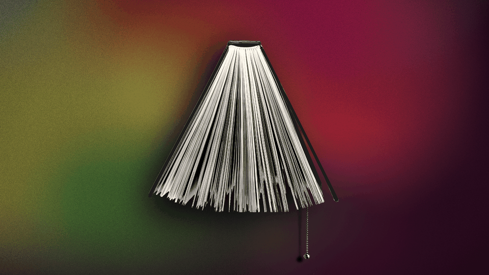 A book in the shape of a lampshade with a lamp cord hanging from the bottom.