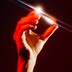 A hand holding a crystal