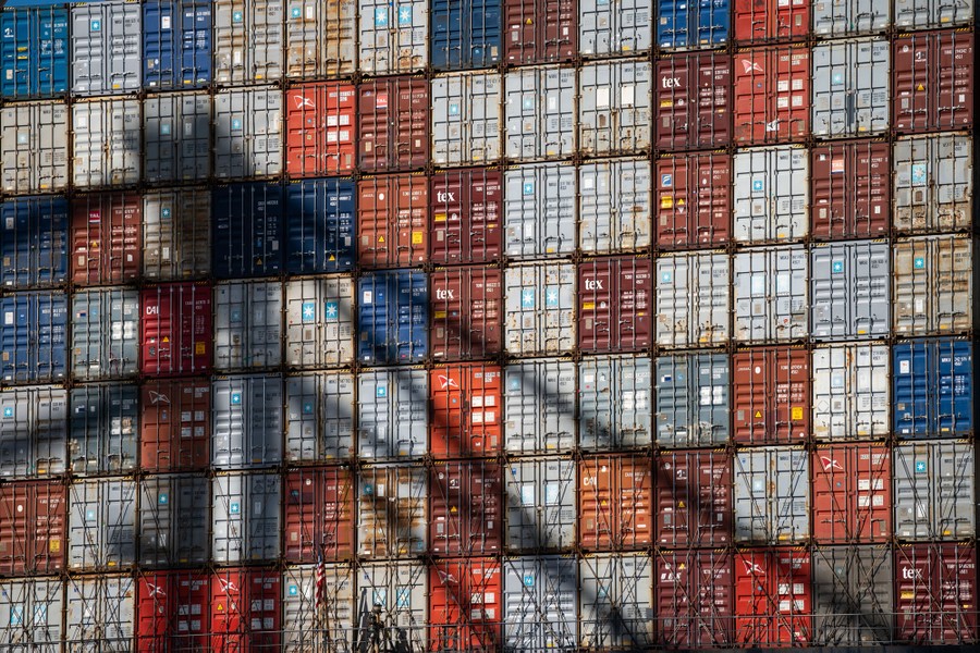 A grid is formed by dozens of stacked shipping containers.