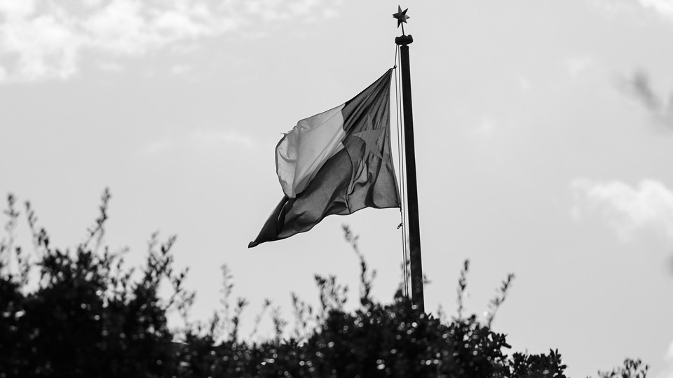 The Texas flag flies above city hall.