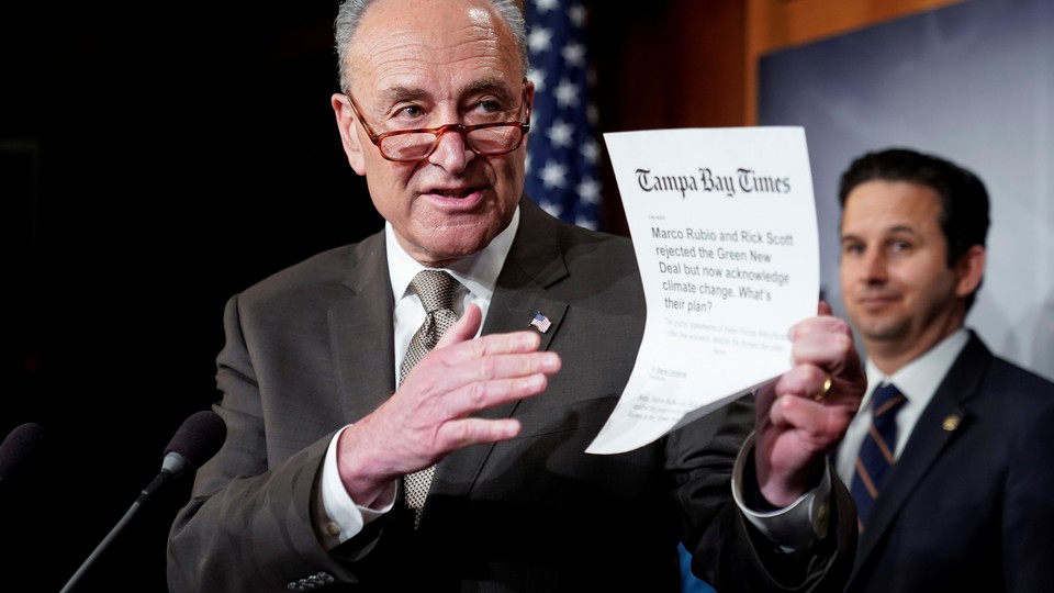 Chuck Schumer holds a printout from the Tampa Bay Times.