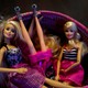 Barbie dolls sit in a basket