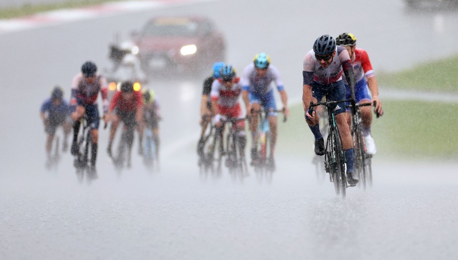 Cyclists race in heavy rain.