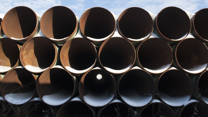 A stack of pipes that have collected snow