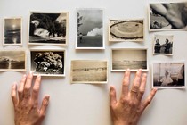 Amelia Walker's hands hover over her collection of snapshots.