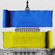 A yellow ribbon and a blue ribbon superimposed on a photo of Congress