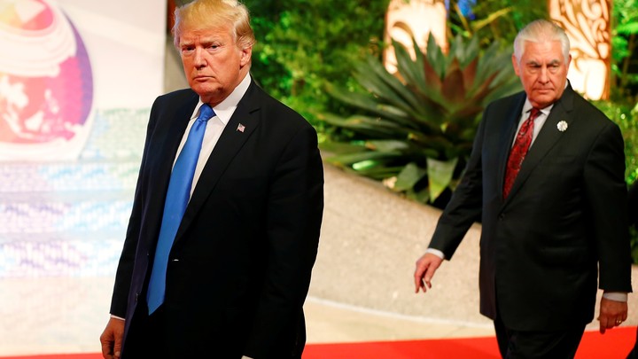 President Trump walks ahead of Secretary of State Rex Tillerson.