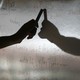 A hand hovers over a dry-erase board, casting a shadow.