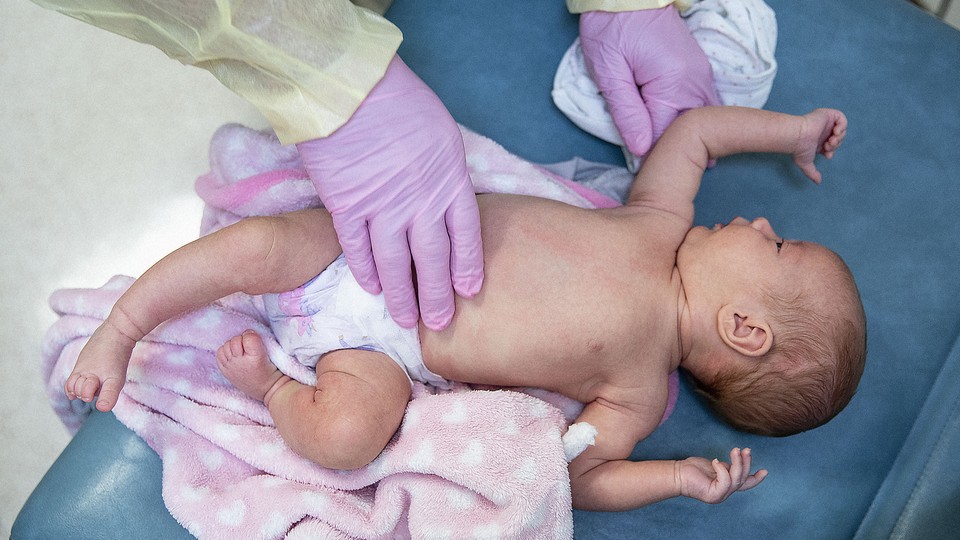 a photo of an infant in a hospital care setting, taken from above