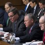 Five men from the Senate Intelligence Committee sit at a desk