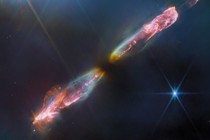 An image from the James Webb Space Telescope of a protostar spewing two jets of luminous cosmic material