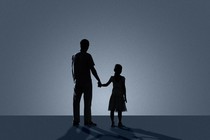 Sillhouettes of a father and daughter holding hands